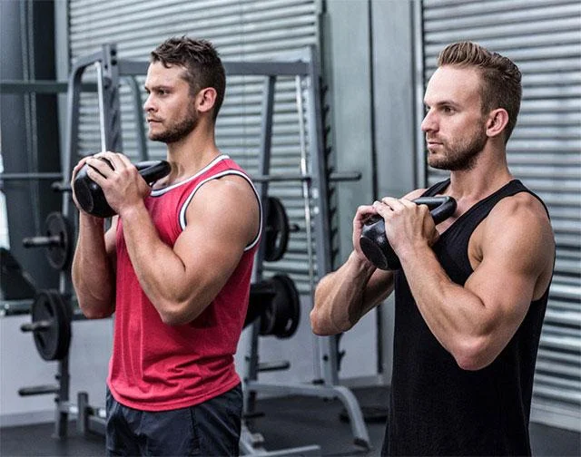 Two men lifting weights in a gym