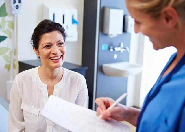 Woman talking to doctor
