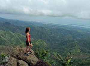 woman on top of mountain - Chronic Fatigue