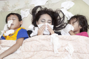 Family is lying on a bed with flu - direct primary care Oak Brook, IL