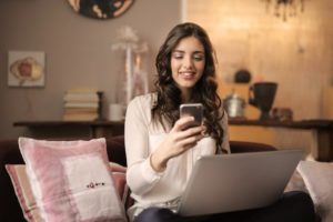 woman smiling at her phone